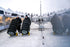 Two technicians using Gaither Smart Carts to transport studded tires outdoors at a racing event