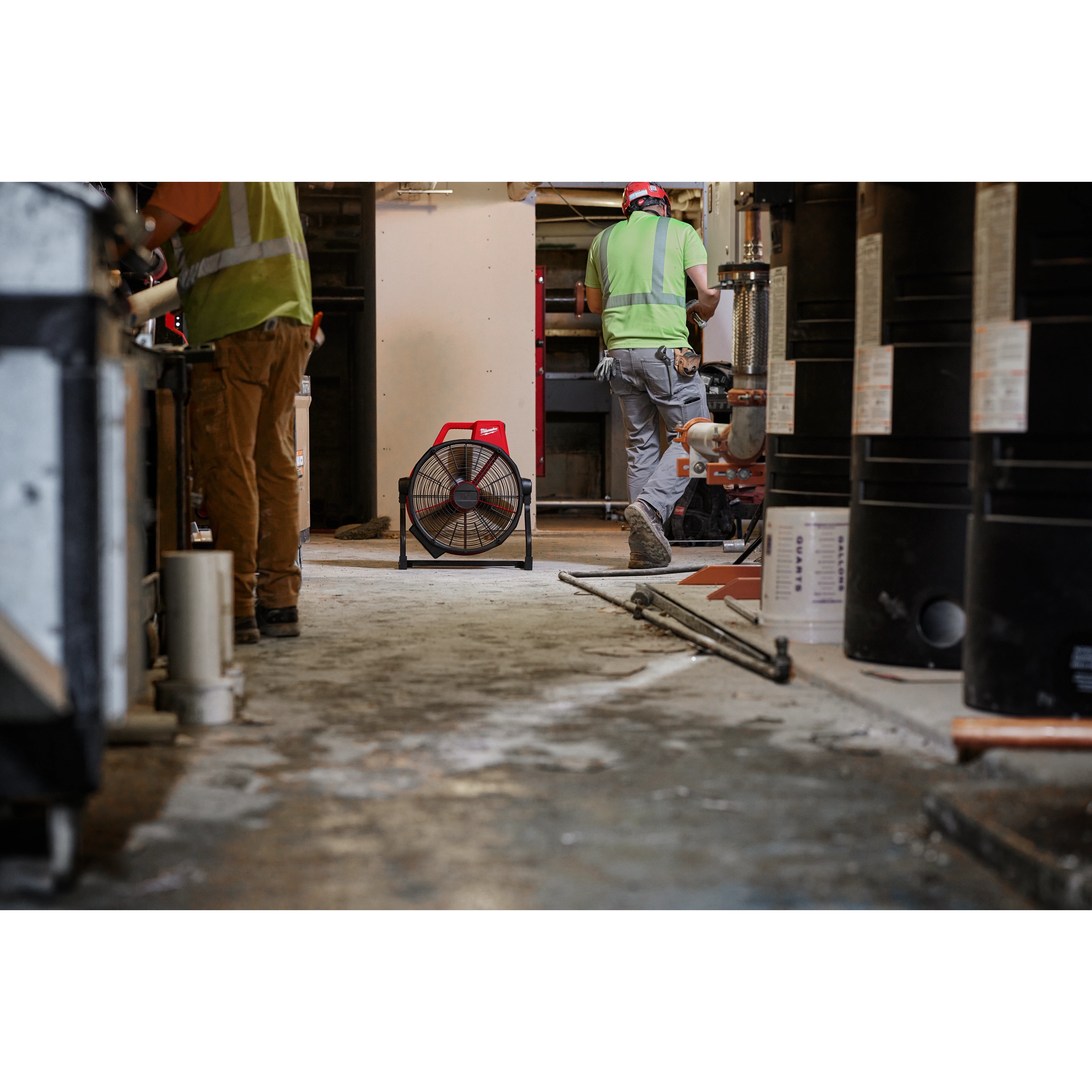 Milwaukee Tool 0821-20 M18 Brushless 18" Fan - job site lifestyle photo with workers in background