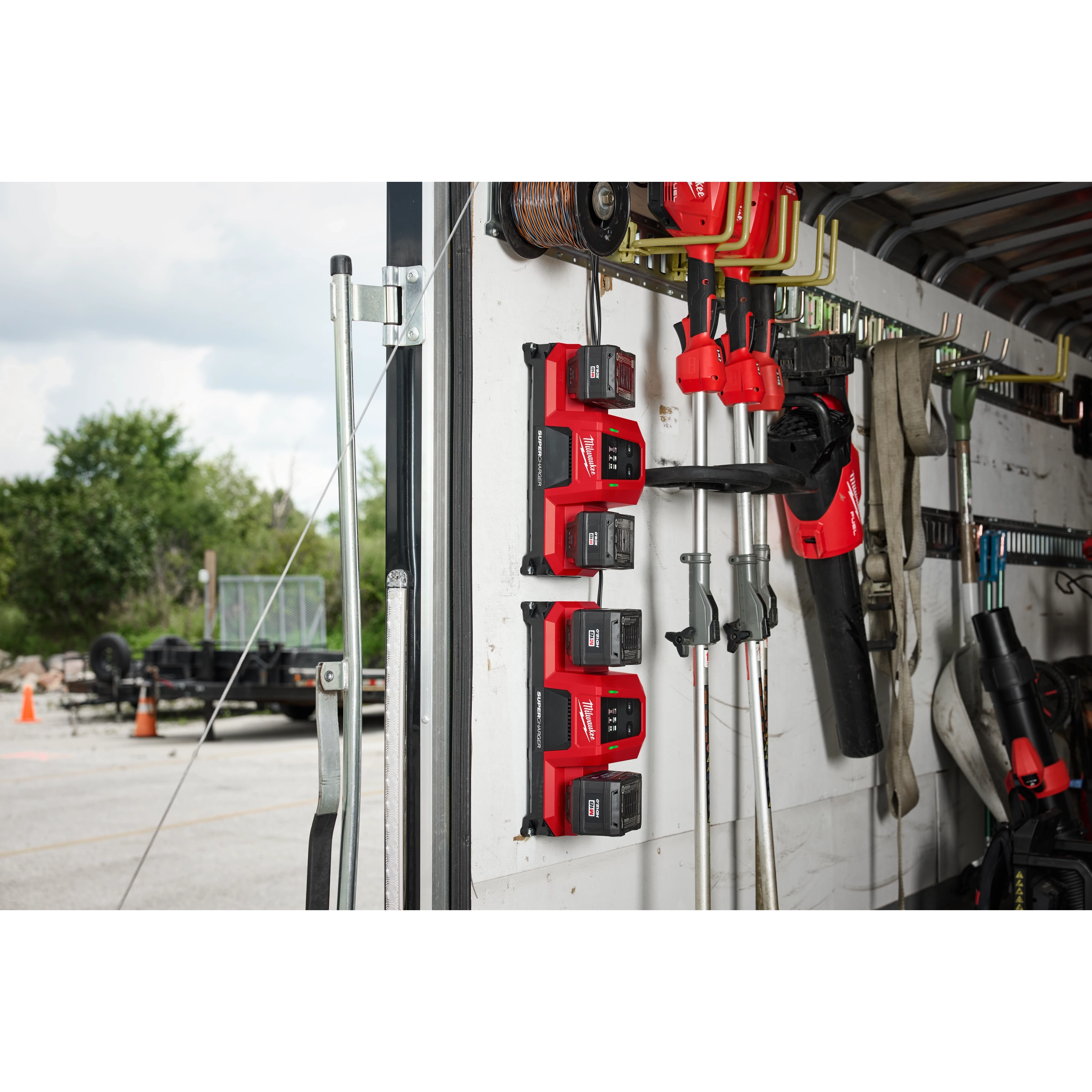 Milwaukee M18 Dual Bay Super Chargers mounted vertically in a work van or trailer for on-the-go charging