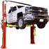 Coats 4T212SSR1 12,000 lb symmetrical 2-post vehicle lift raising a white Chevy 3500 HD truck