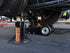 AME International 14400 22-Ton Heavy Duty Jack Stand in use under a commercial vehicle on a paved surface