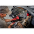 Mechanic using Milwaukee M12 FUEL Bandfile for automotive undercarriage rust removal