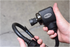 Astro Pneumatic ONYX 1/2 Inch Palm Impact Wrench close-up with socket and hose loop, in-use lifestyle shot
