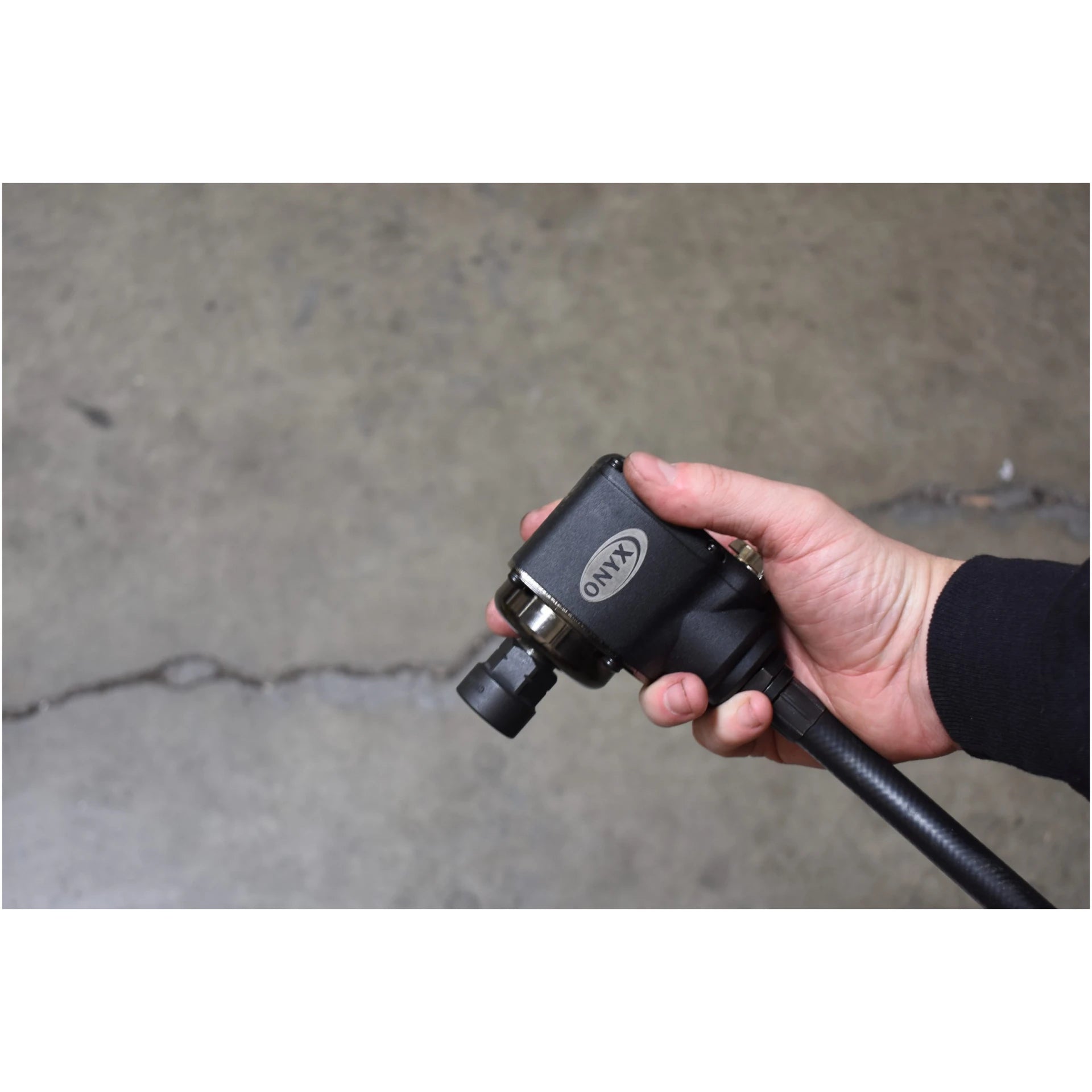 Astro Pneumatic ONYX 1/2 Inch Palm Impact Wrench gripped in palm demonstrating reactionless compact head