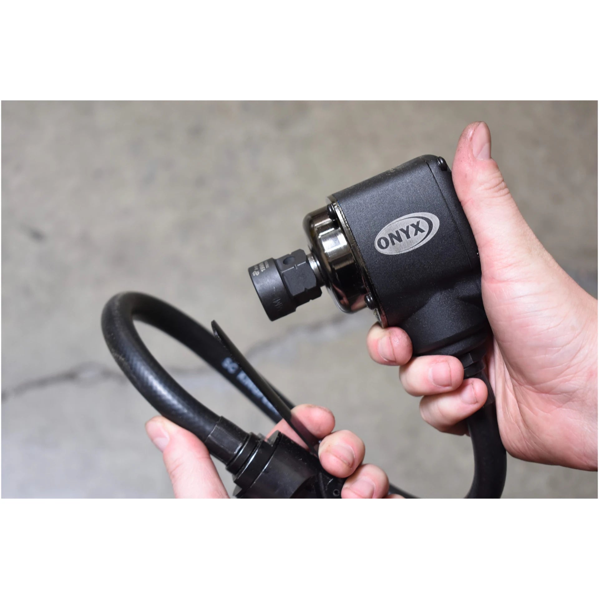Astro Pneumatic ONYX 3/8" Palm Impact Wrench in use with socket attached, two-hand grip