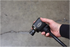 Astro Pneumatic ONYX 3/8" Palm Impact Wrench gripped in one hand showing compact palm-size design