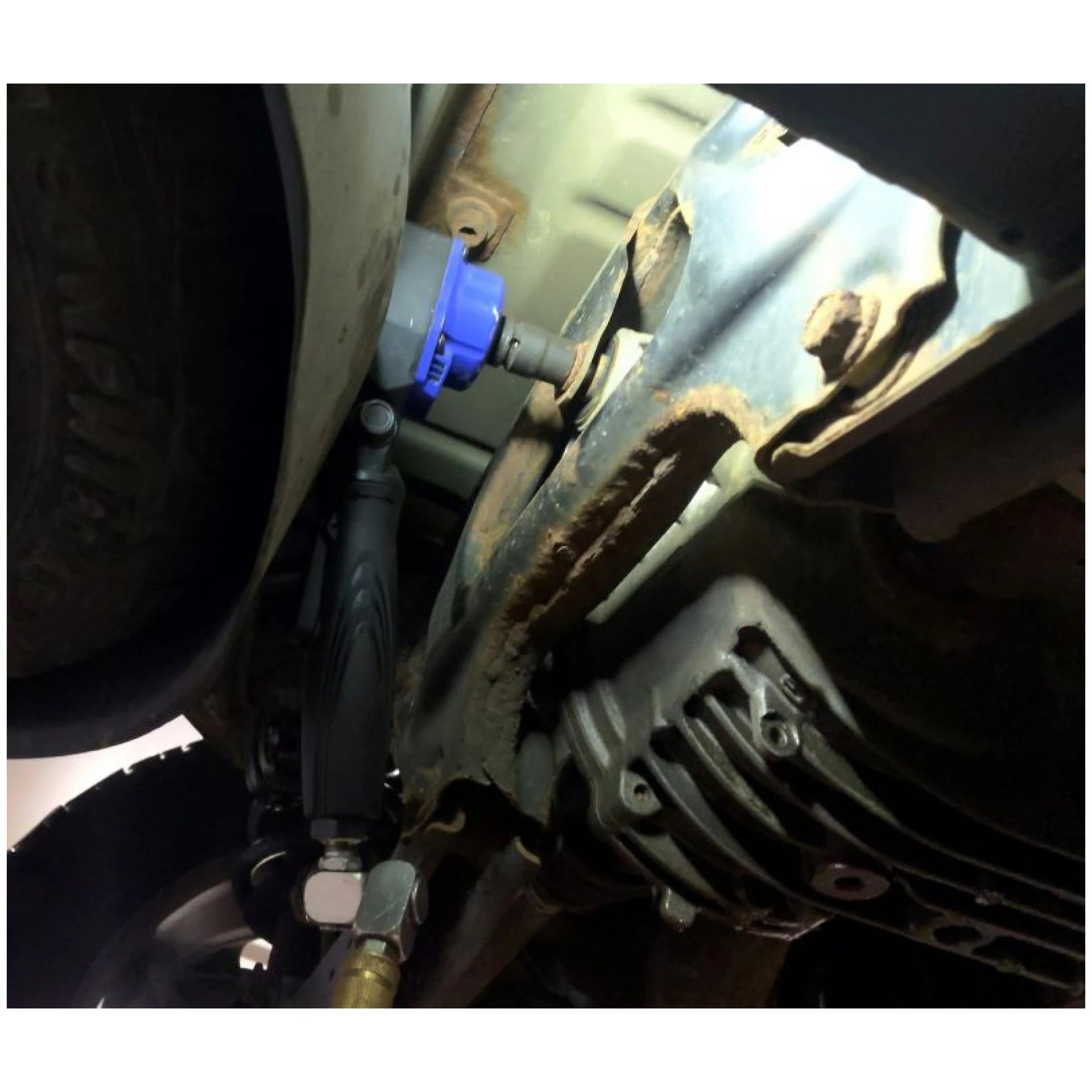 Astro Pneumatic 1834 1/2 In Nano Flex-Head Angle Impact Wrench in use under vehicle close-up