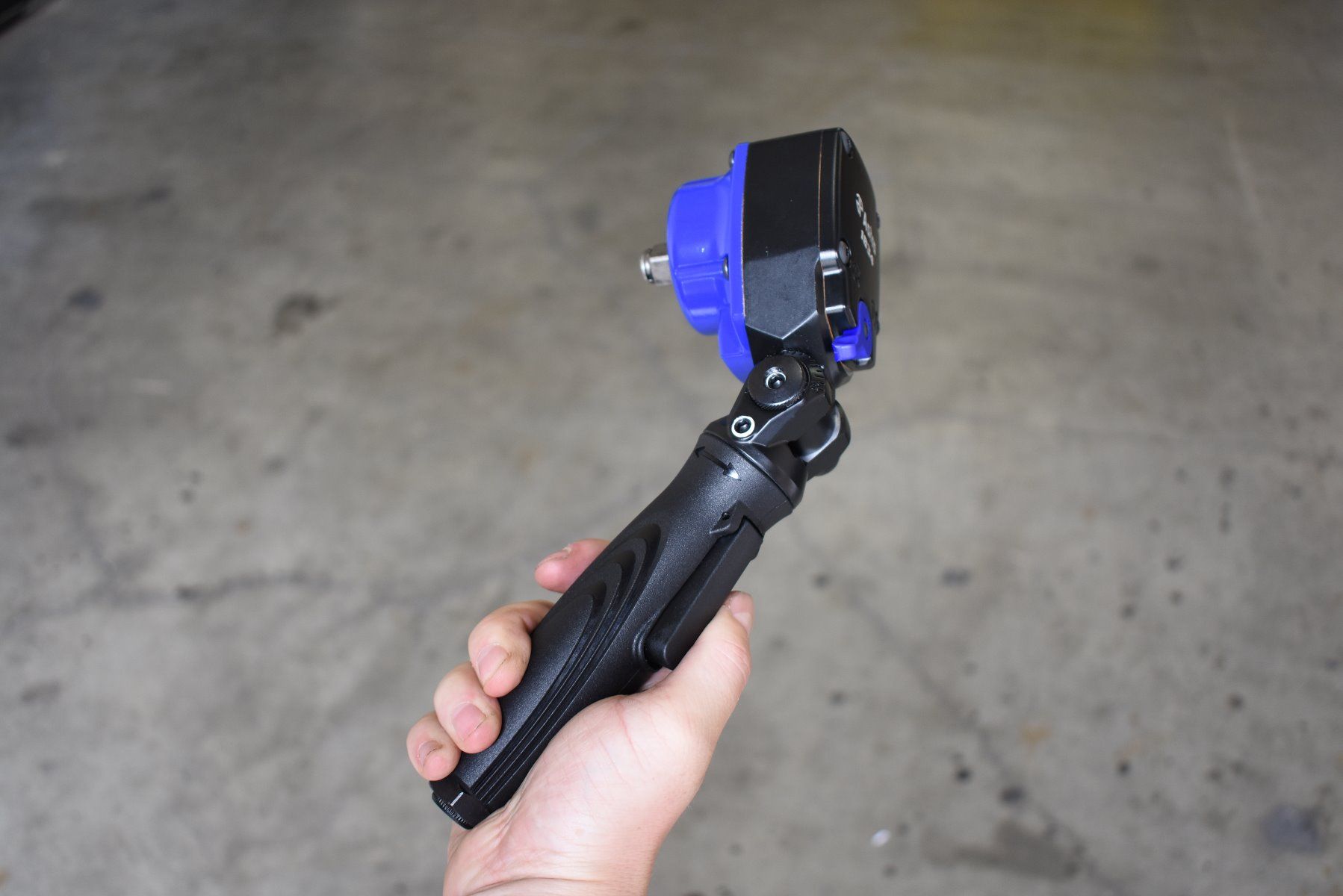 Astro Pneumatic 1834 1/2 In Nano Flex-Head Angle Impact Wrench held in hand at an angle