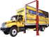 Coats 4T220SSR1 20,000 lb Two Post Lift lifting a large yellow Penske box truck