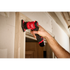Milwaukee M12 FUEL Orbital Detail Sander in use sanding door trim on jobsite