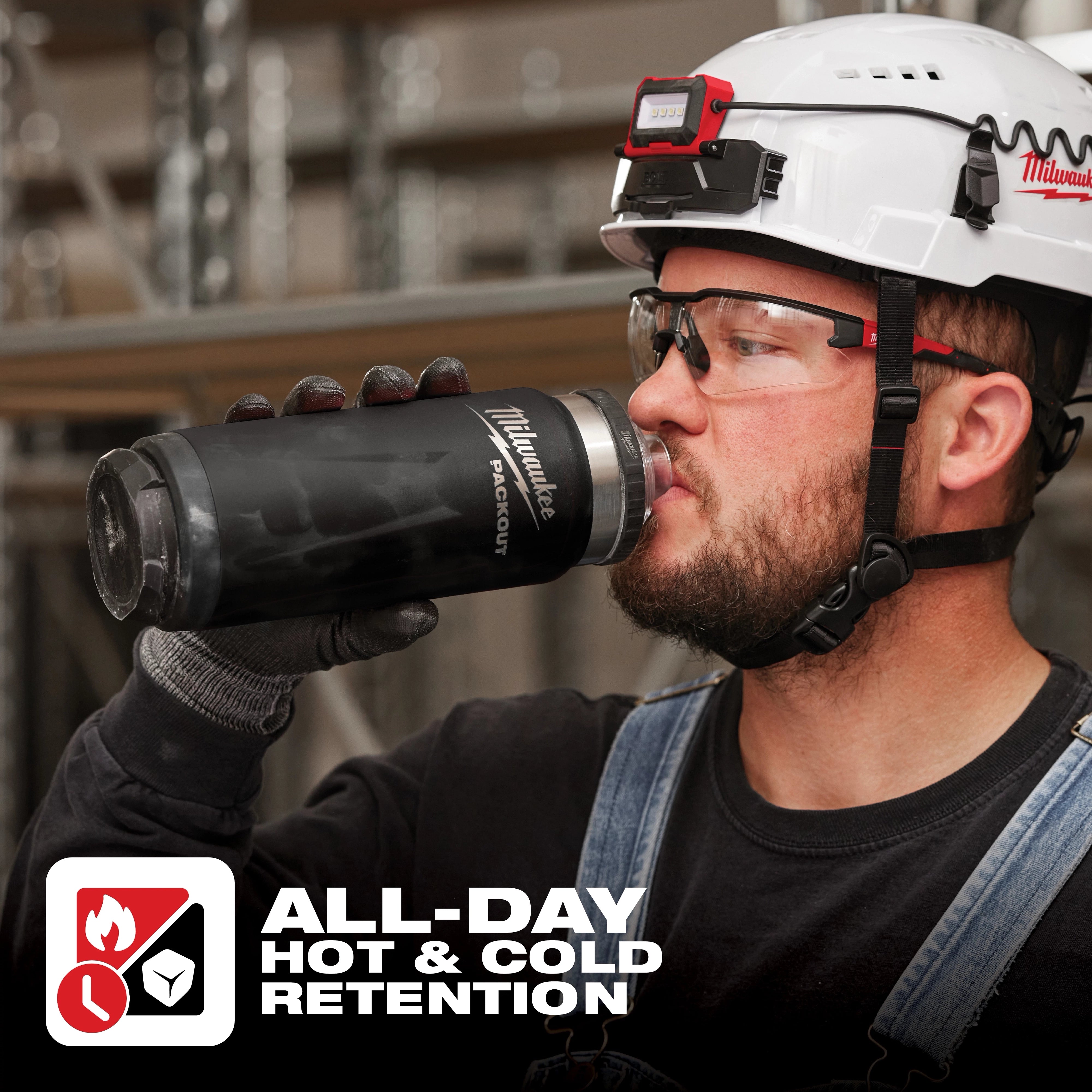 Worker drinking from Milwaukee PACKOUT 24oz Insulated Bottle on jobsite - All-Day Hot and Cold Retention