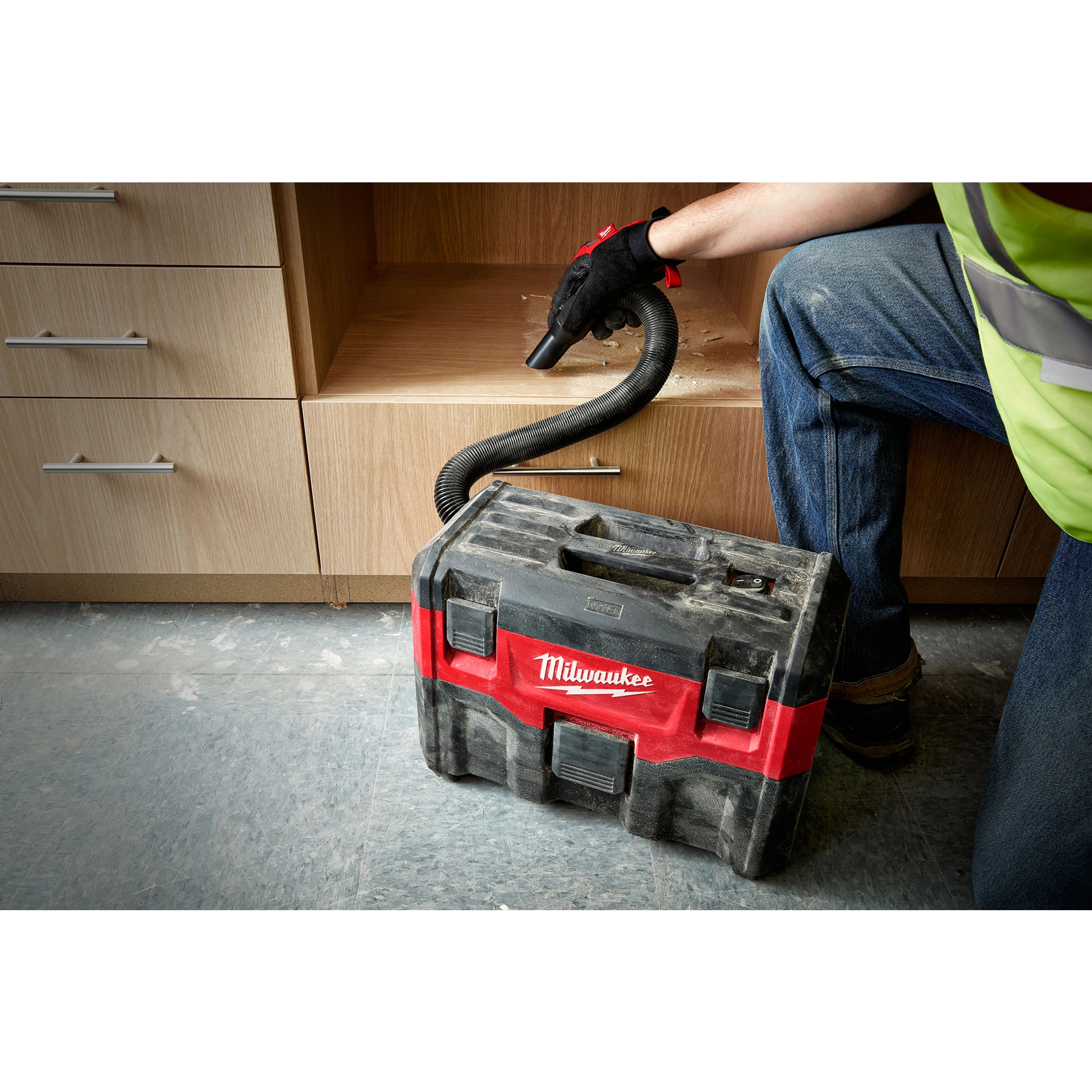 Milwaukee Tool 49-90-2014 Expandable Hose in use with Milwaukee M18 wet/dry vacuum on a jobsite