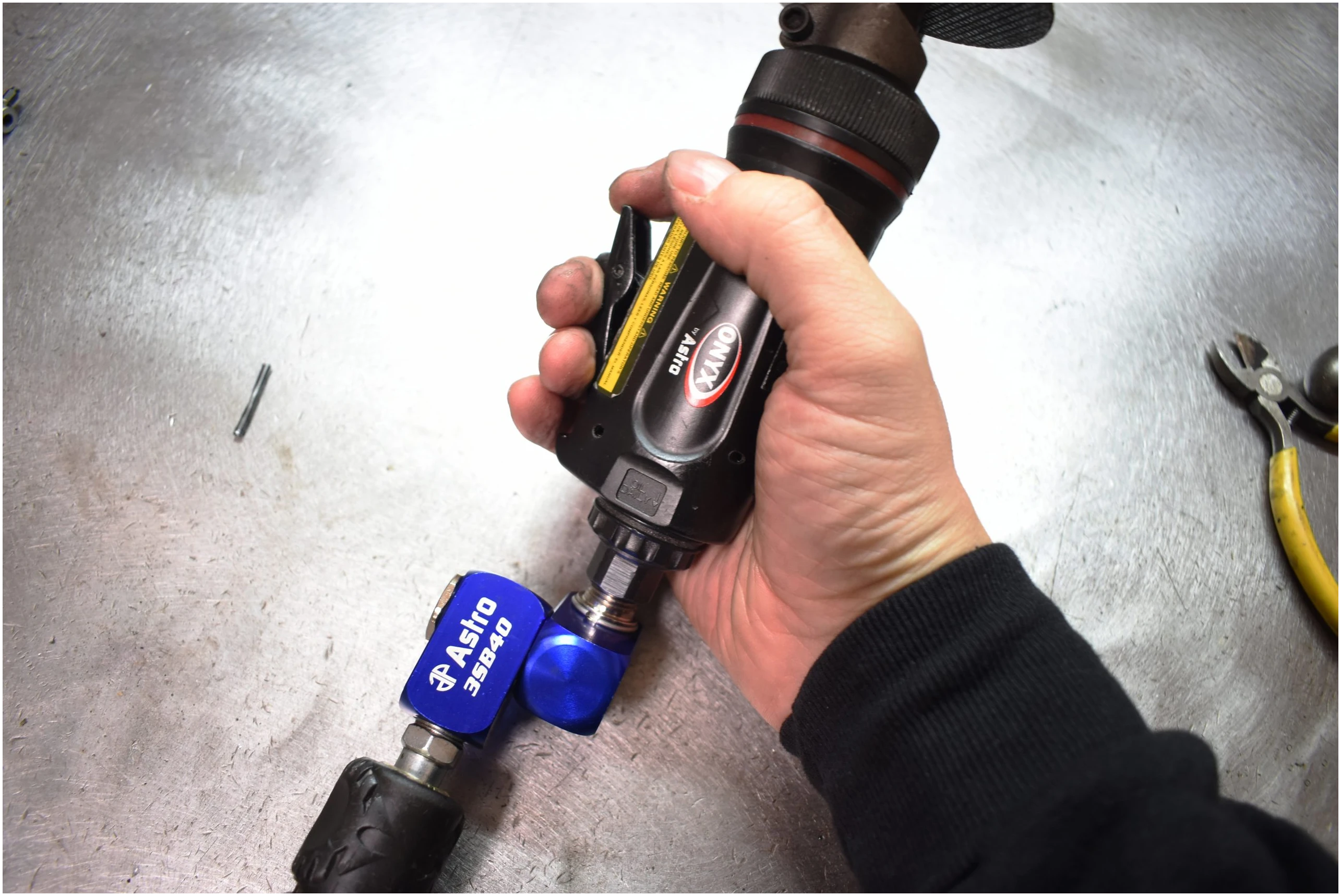 Astro Pneumatic 3SB40 Air Swivel connector attached to Astro ONYX air tool - in-use lifestyle photo