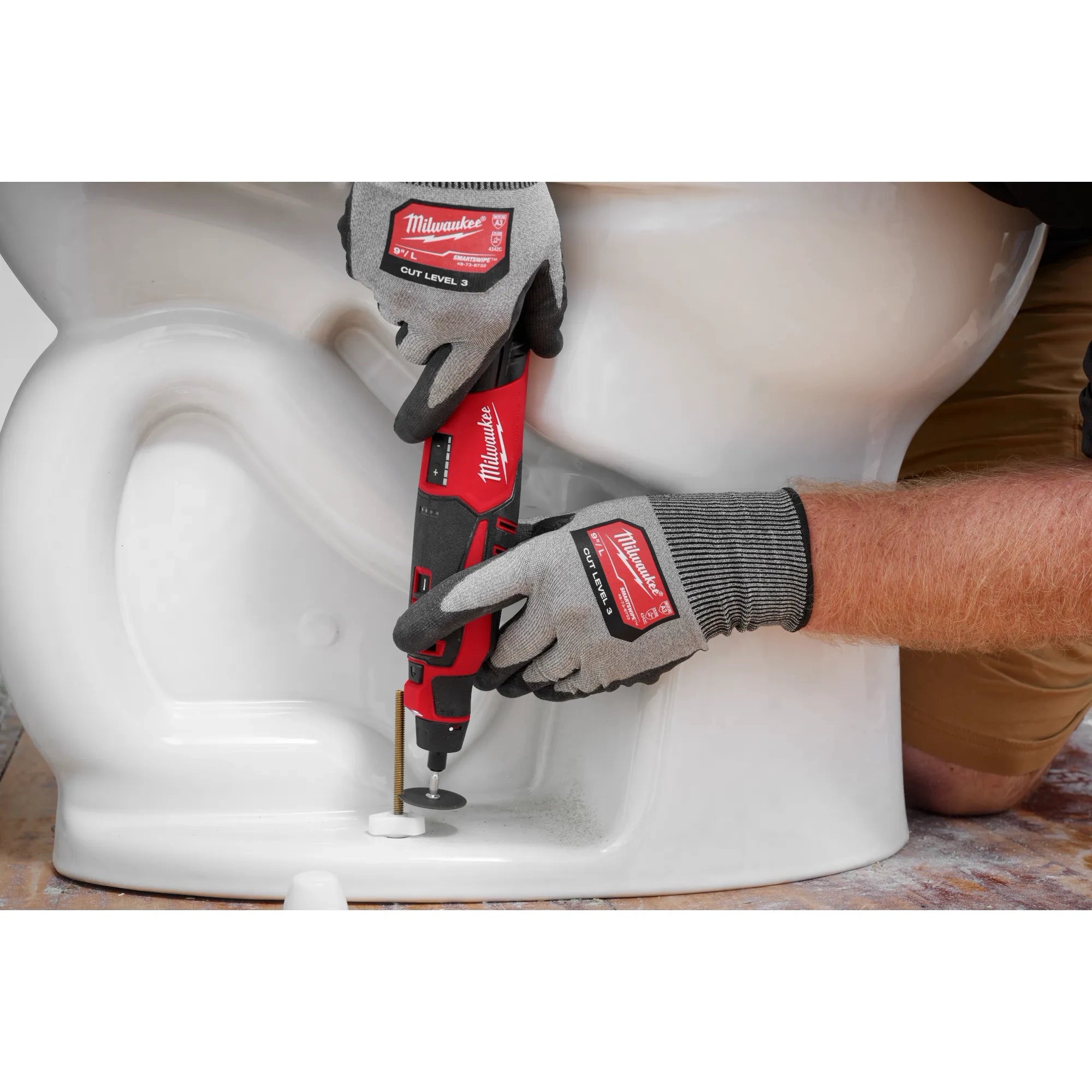 Milwaukee Tool 2525-20 M12 Brushless Rotary Tool in use on a plumbing application near a toilet base