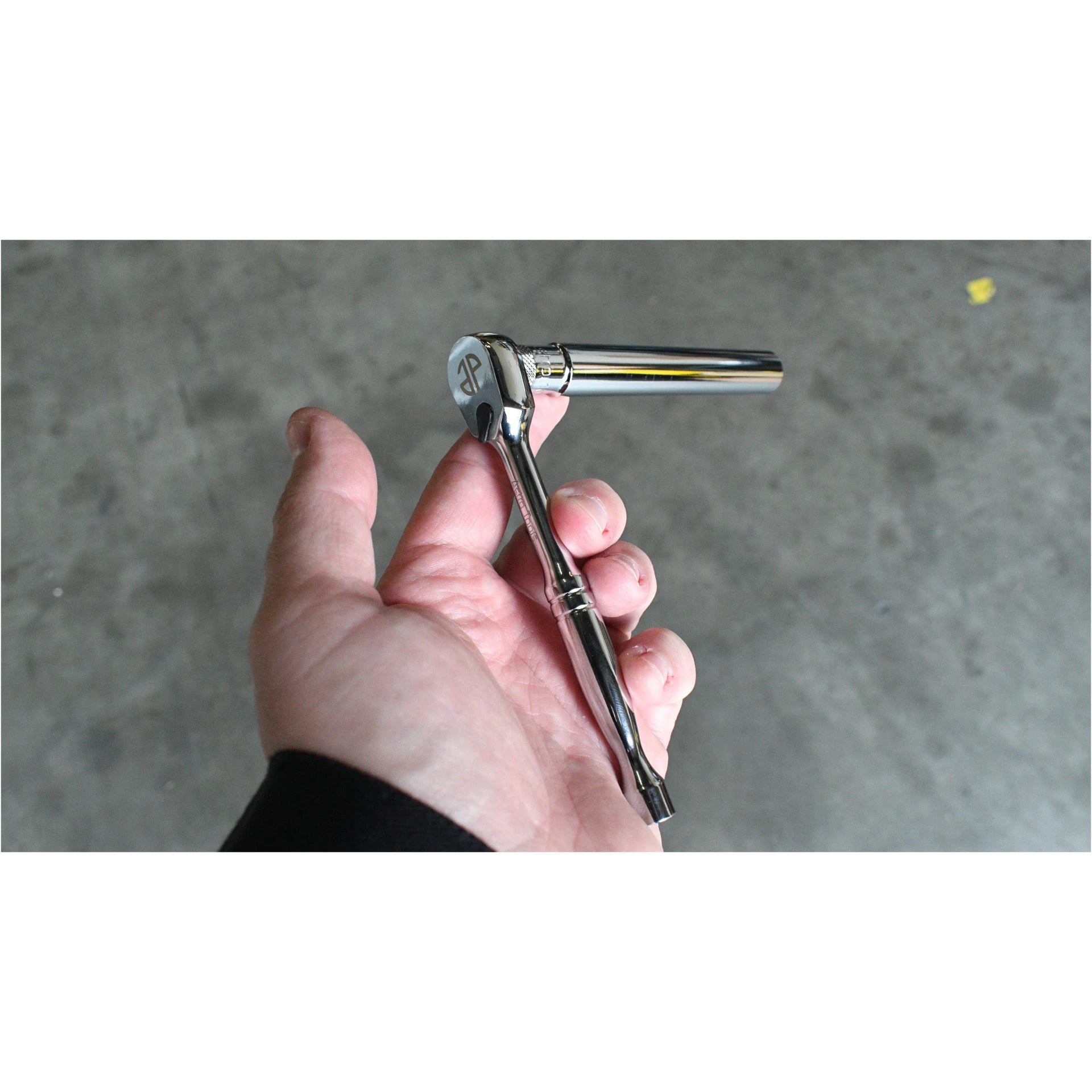Astro Pneumatic extra deep 1/4 drive socket on ratchet lifestyle shot, hand holding tool