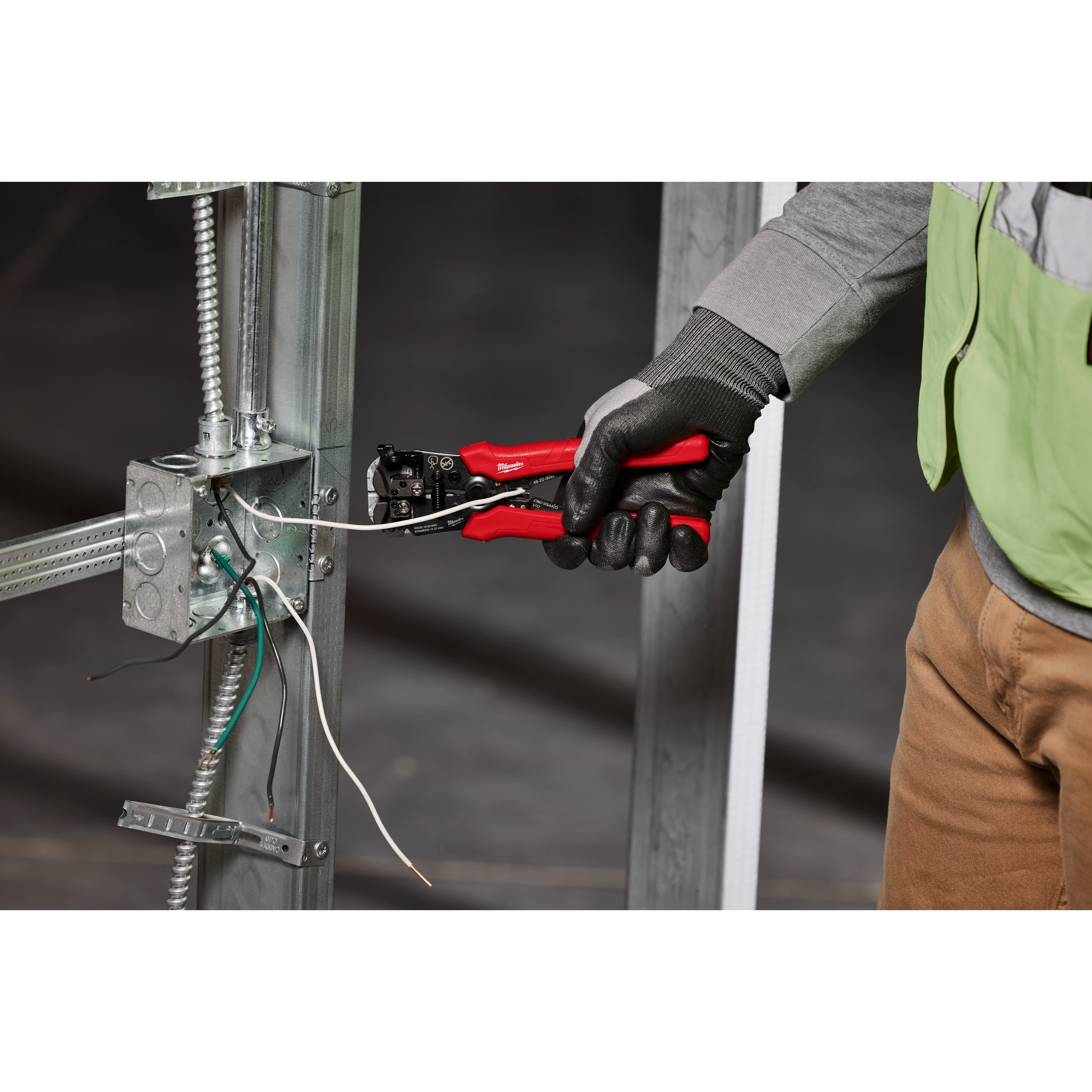 Milwaukee Tool 48-22-3082 Self-Adjusting Wire Stripper in use stripping NM cable at electrical panel