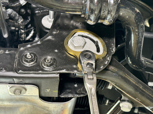 Lisle 41620 cam holding tool in use on GM vehicle control arm cam with ratchet wrench