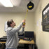Alert Stamping 5000M-30GF-CB Retractable Cord Reel ceiling-mounted in workspace with cord being pulled down
