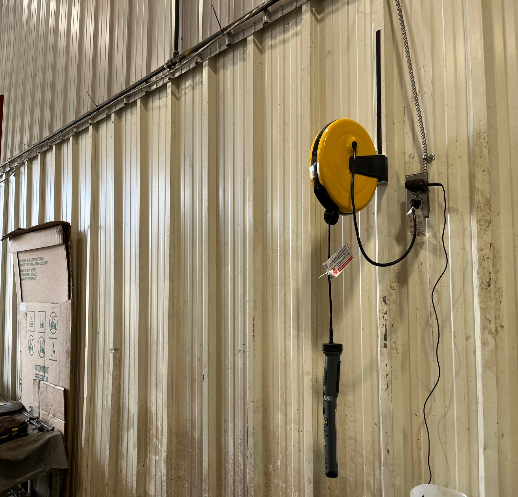 Alert Stamping 5050CL8 ProReel retractable cord reel wall-mounted in an indoor workshop
