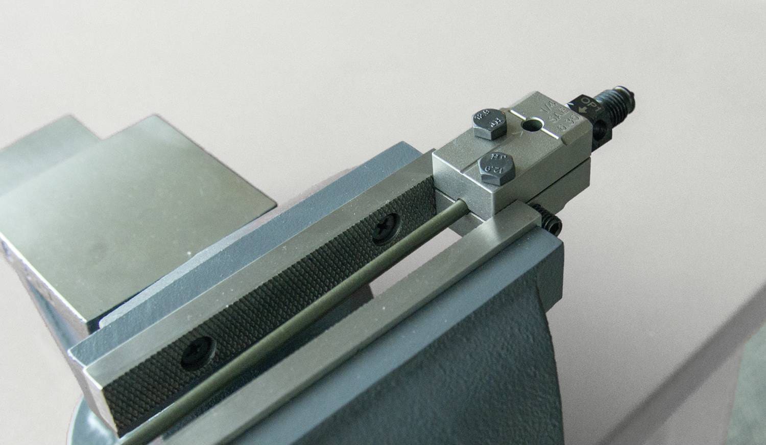 Titan Tools 51515 1/4 In Double Flaring Tool mounted in bench vise without handle, showing on-car and bench use versatility