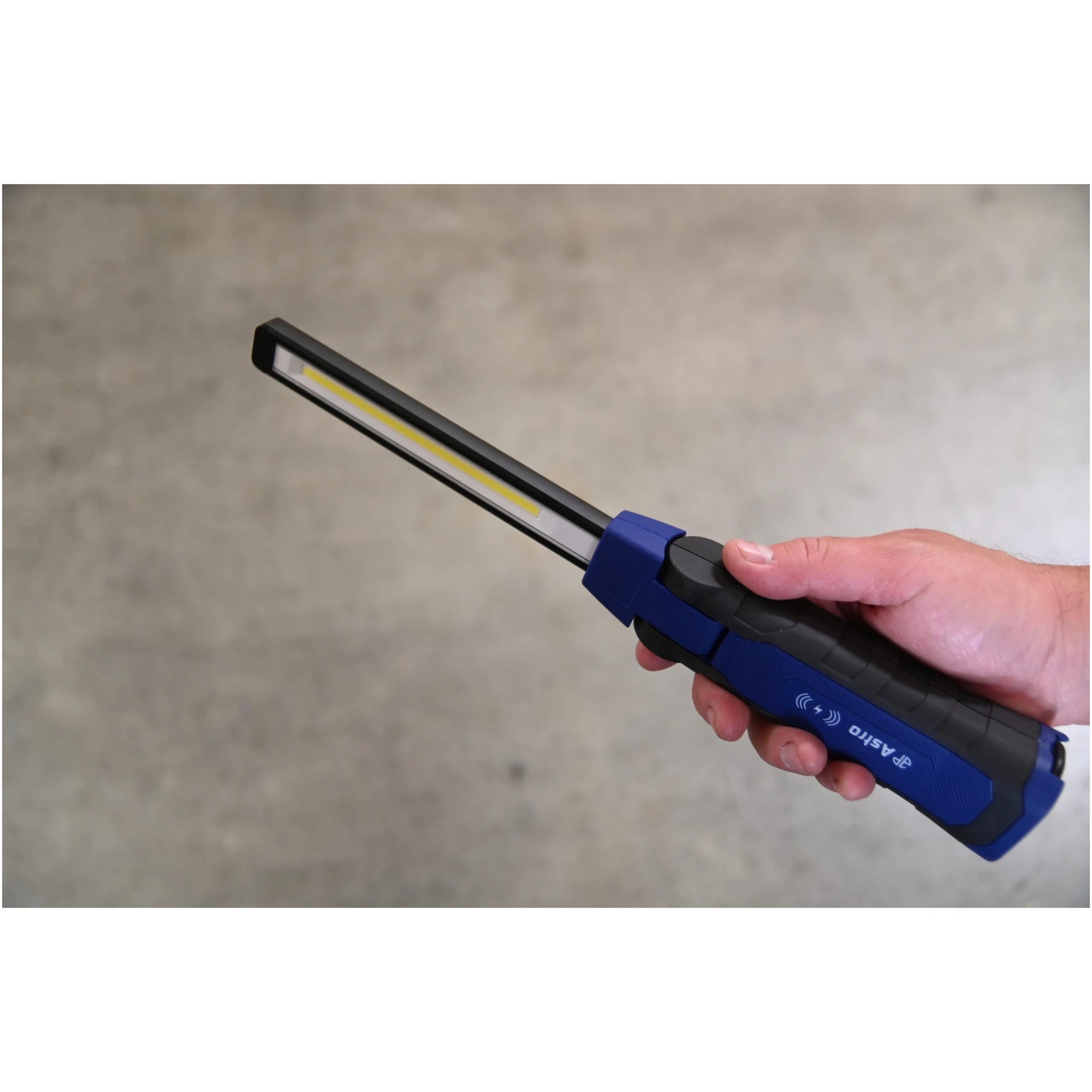 Hand holding Astro Pneumatic 52SLMAX LED Slim Light showing back side and folding joint