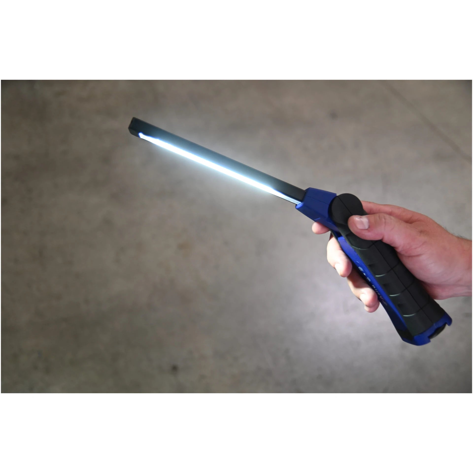 Hand holding Astro Pneumatic 52SLMAX LED Slim Light with front bar fully illuminated