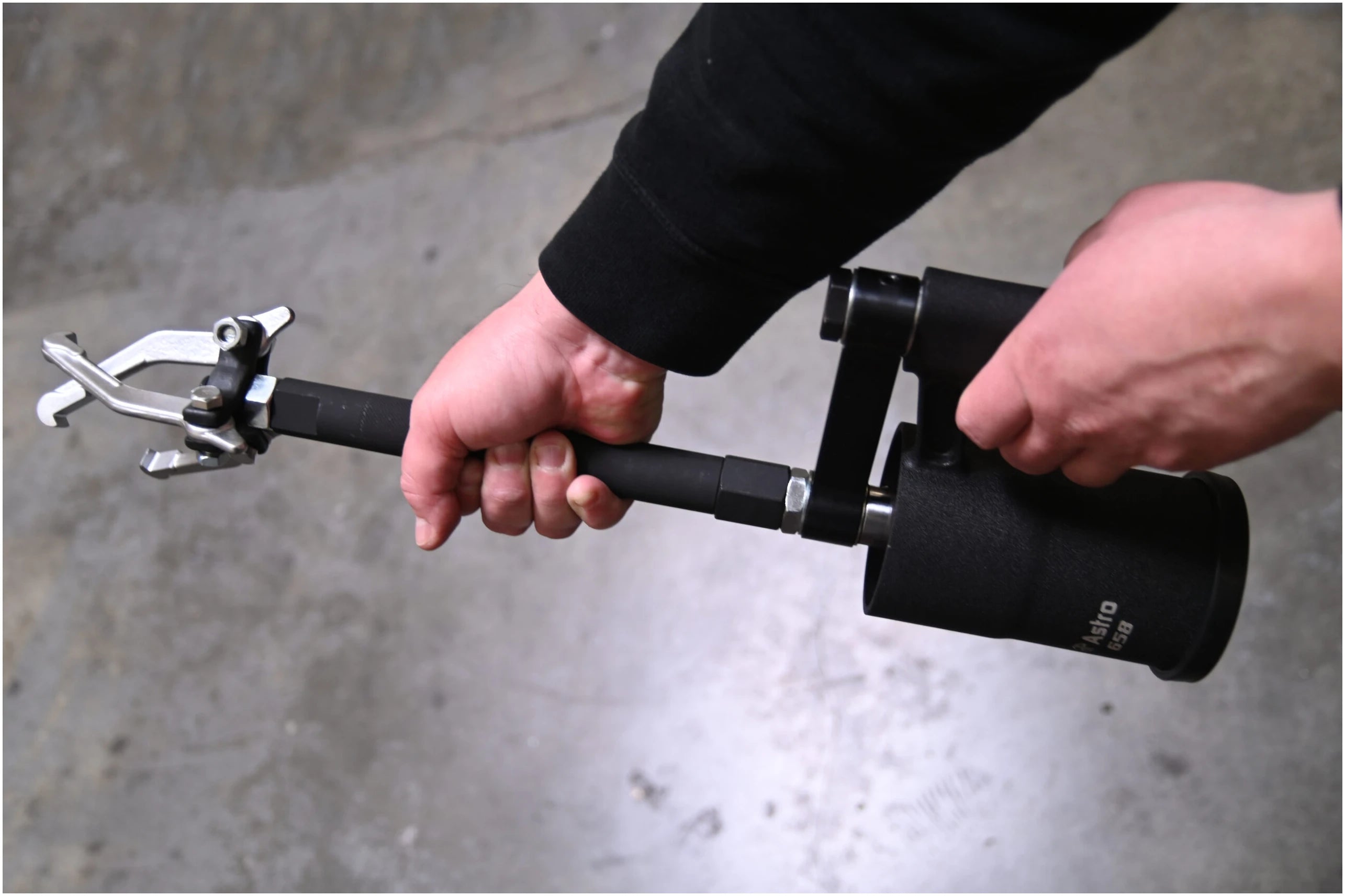Astro Pneumatic 658 Stubby Air Slide Hammer being operated with bearing puller attachment in garage