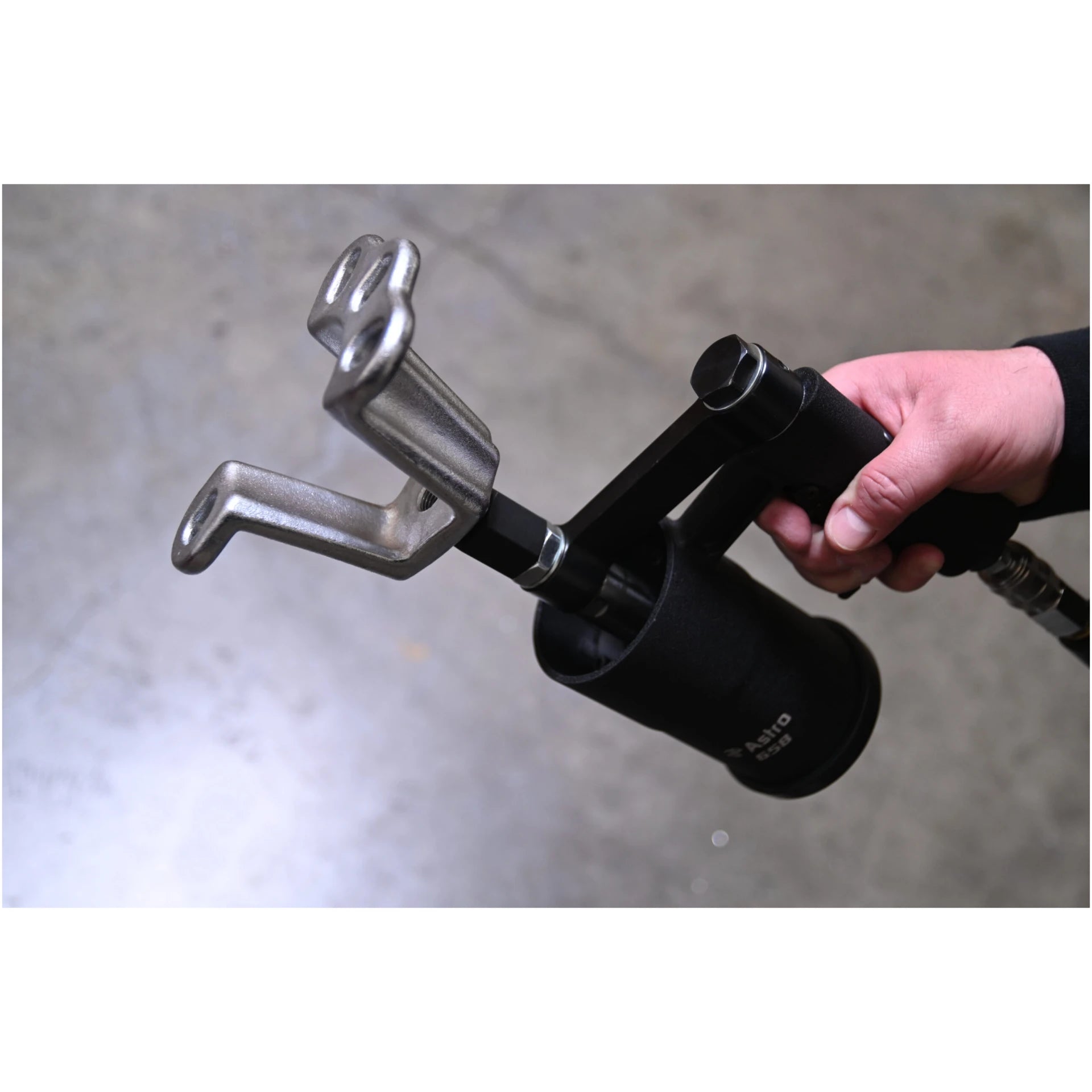 Astro Pneumatic 658 Stubby Air Slide Hammer in use with hook slide hammer attachment