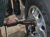 AME International 67300 Nut Buddy Lug Loosener in use on commercial truck wheel hub