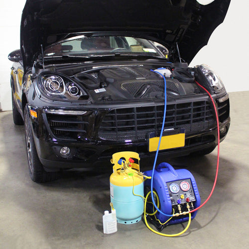 Mastercool 69110 Automotive A/C Recovery System in use connected to a vehicle engine bay with recovery tank and hoses
