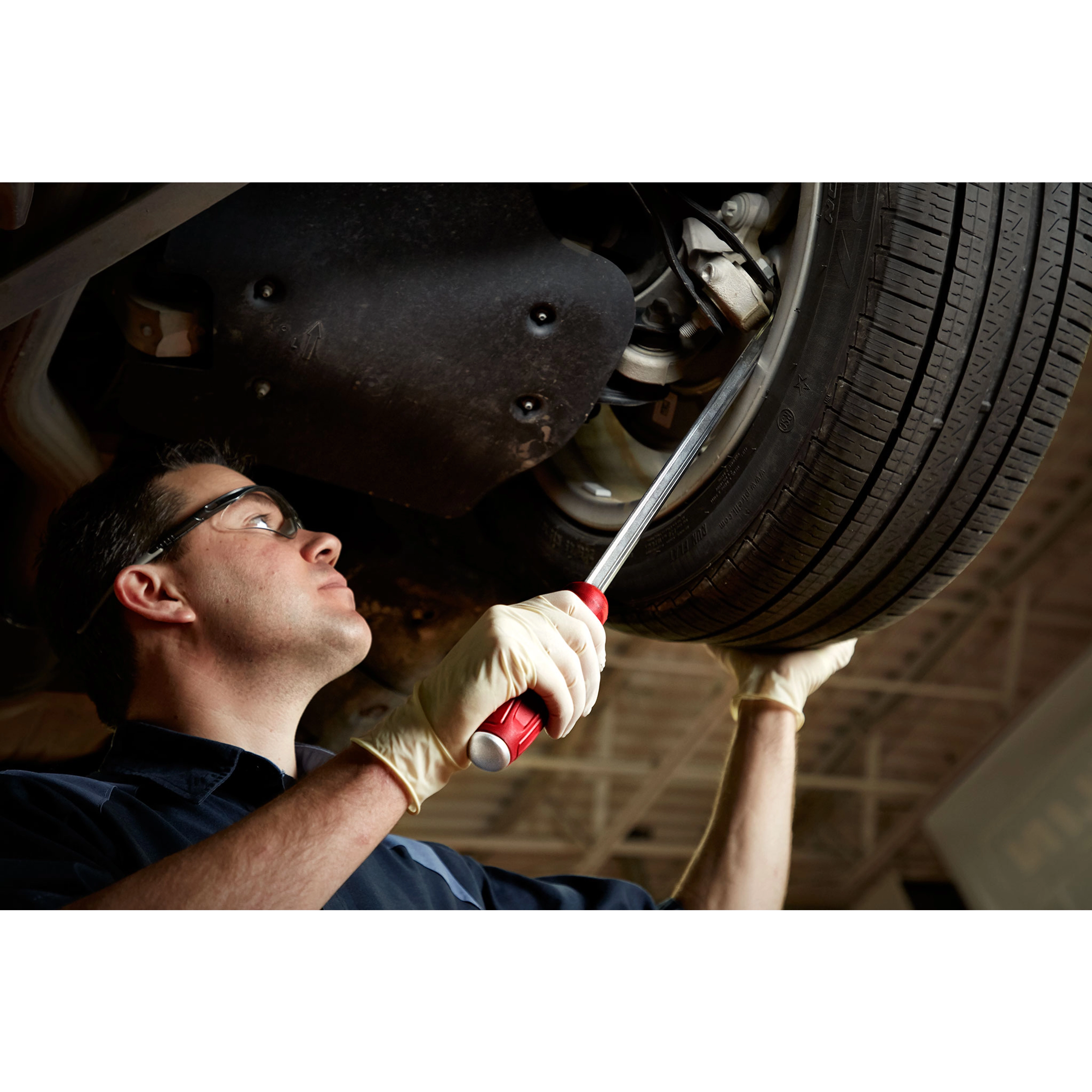 Milwaukee Tool 45-74-9224 24" Pry Bar in use by mechanic under a vehicle