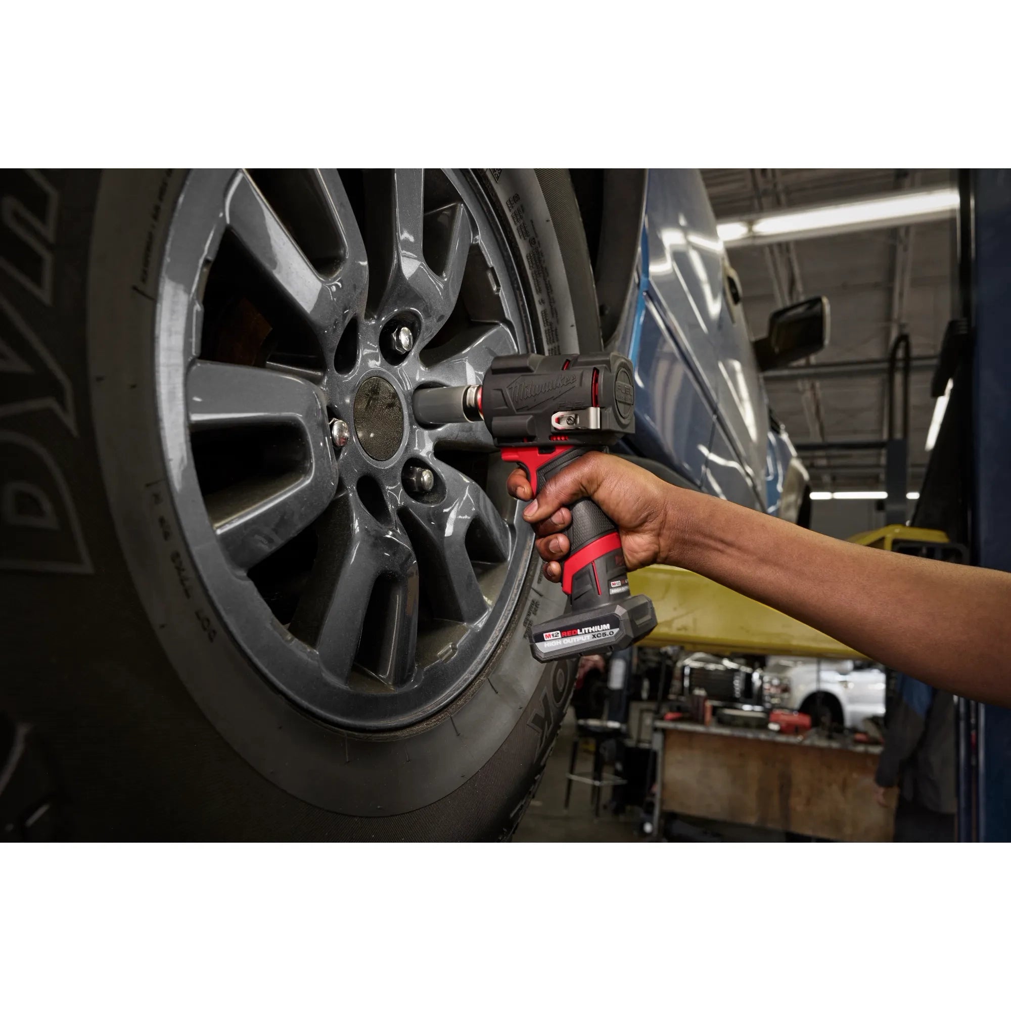 Milwaukee Tool M12 FUEL Stubby Impact Wrench with Protective Boot used in automotive tire shop