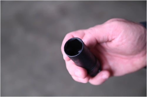 Close-up top view of Astro Pneumatic thin wall lug nut socket held in hand showing hex opening