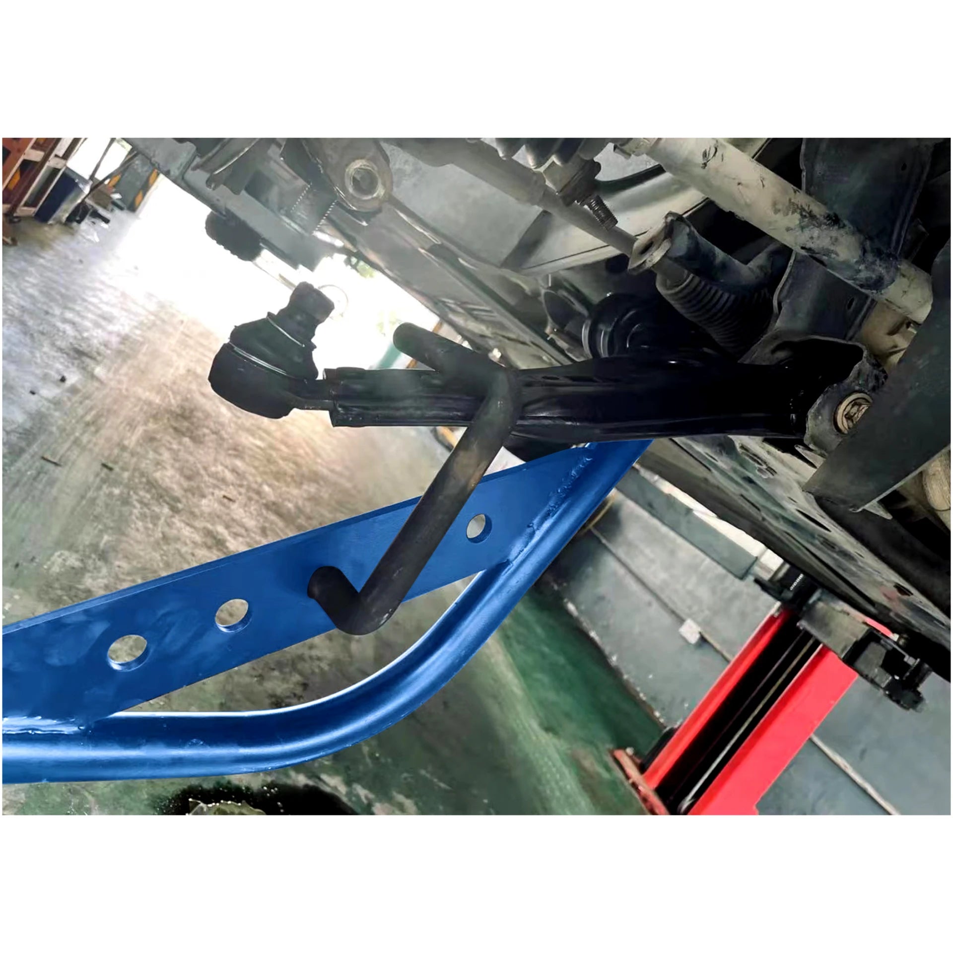 Astro Pneumatic 78914 Lower Control Arm 4ft Pry Bar in use under vehicle freeing control arm