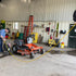 Alert Stamping 8150MP ProReel Retractable Cord Reel in use at commercial workshop, yellow cord extended across garage floor