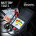 Schumacher BT-100 Battery Load Tester in use on a vehicle battery, showing Load, Battery Condition, and Starter Motor Draw tests