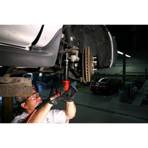 Mechanic using Ajax Tool Works air chisel under a vehicle