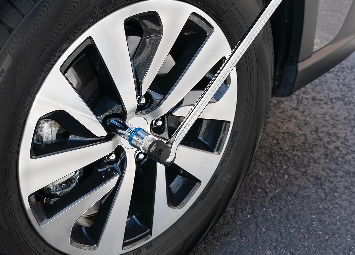 Titan Tools 12109 Ratcheting Breaker Bar Adapter in use on a vehicle wheel hub with breaker bar