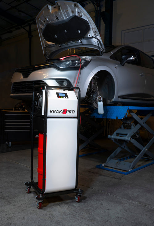 CTA Tools 8485 Brake-Pro Electric Brake Bleeder in use next to a lifted vehicle in a professional garage