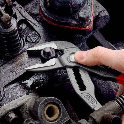 Knipex Cobra ES 87 51 250 extra-slim water pump pliers in use gripping automotive bolt
