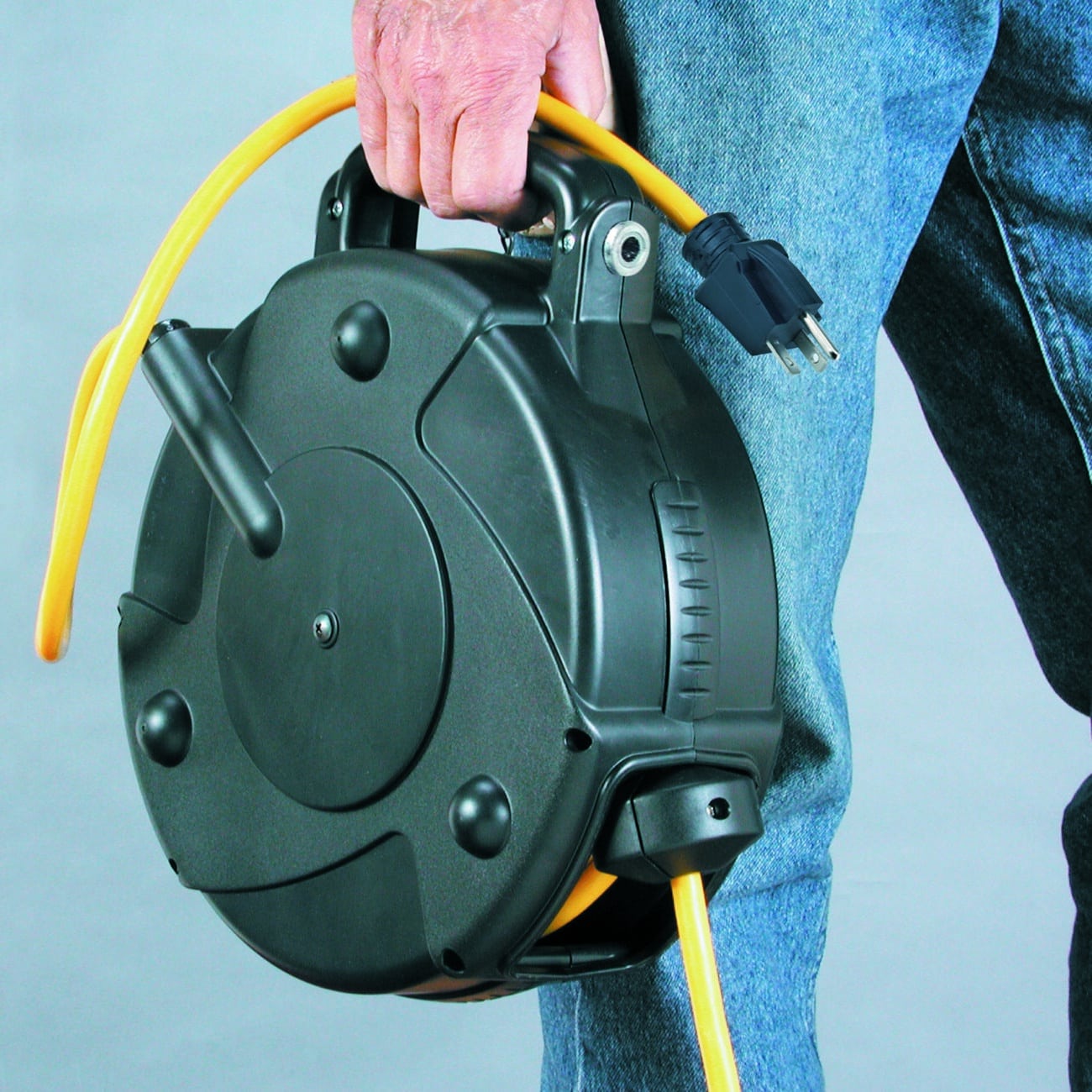 Alert Stamping 8665TFQ Retractable Cord Reel being carried by handle closeup view
