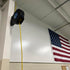 Alert Stamping 8665TFQ Retractable Cord Reel mounted on wall in garage with yellow cord extended