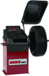 Coats 885 Wheel Balancer full view with hood open and tire mounted
