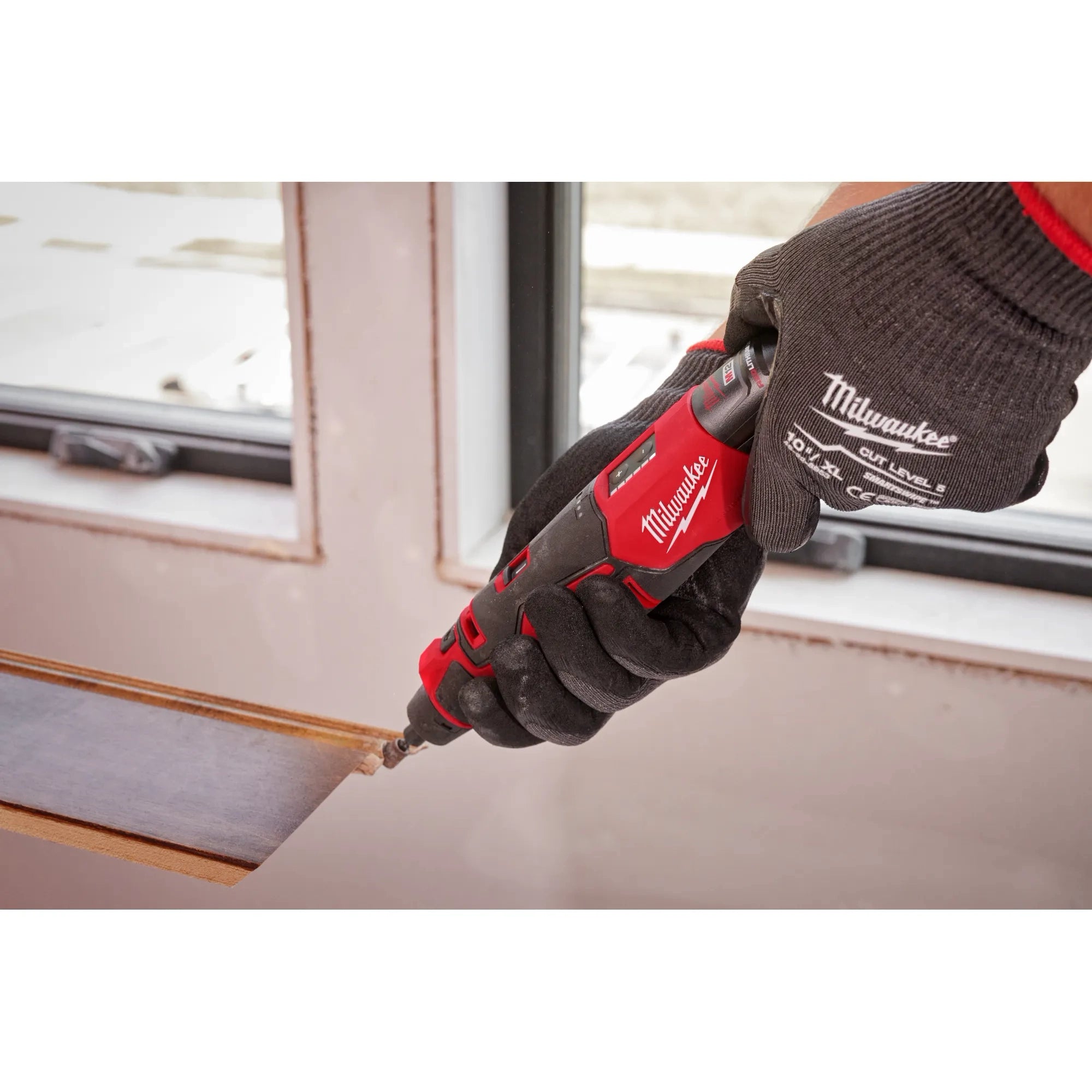 Milwaukee Tool 2525-20 M12 Brushless Rotary Tool in use performing detail cutting on a surface