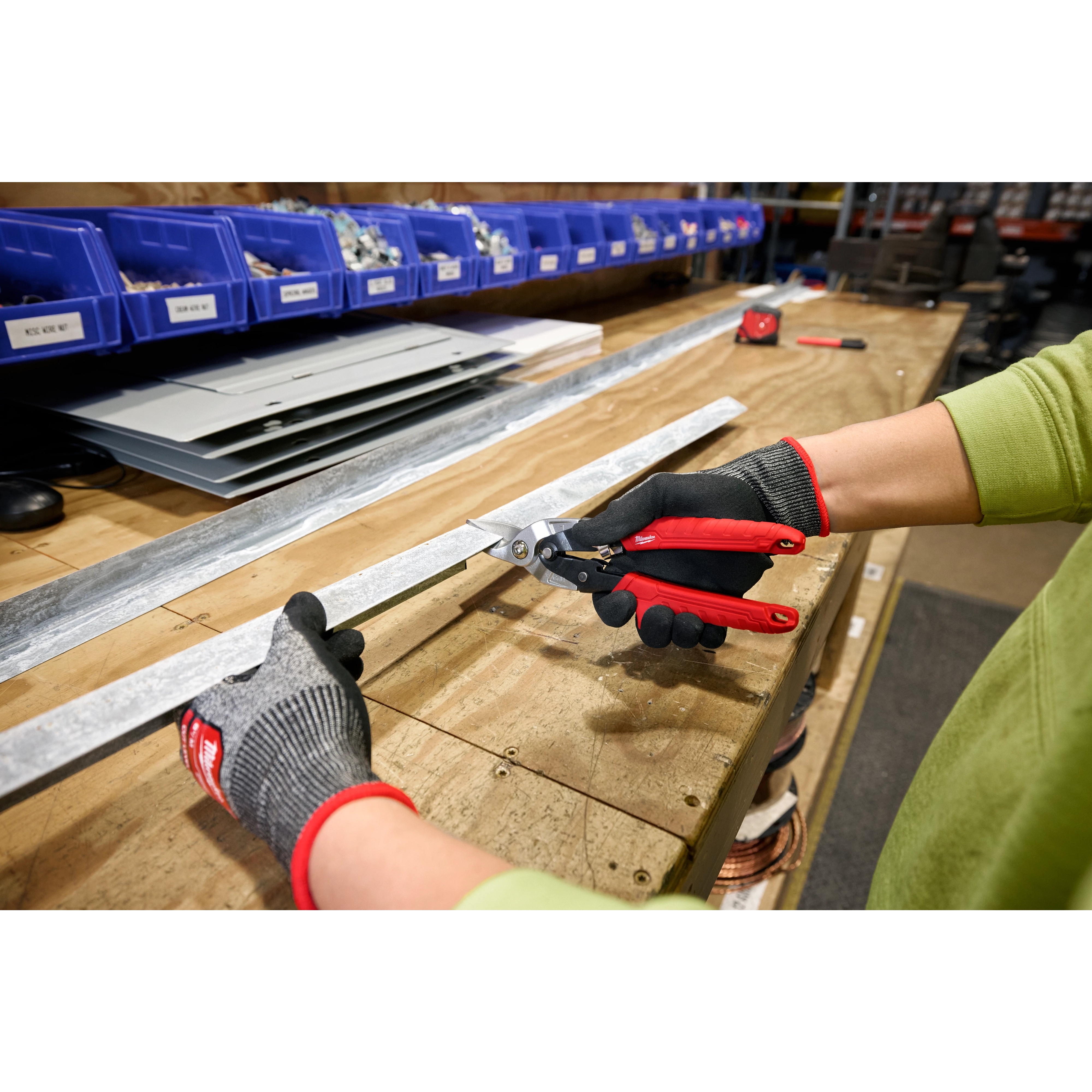 Milwaukee Tool 48-22-4563 Aviation Snips in use cutting sheet metal on workbench