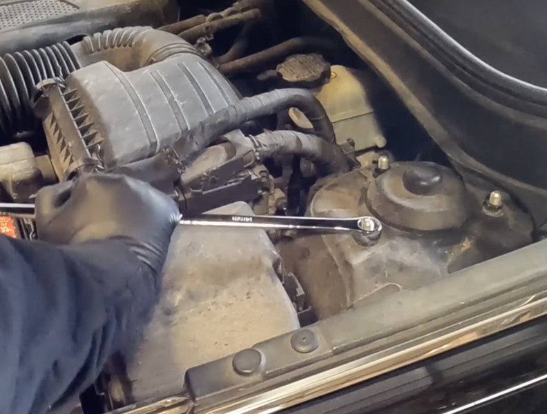 ATD Tools flex head ratcheting wrench in use on a vehicle engine bay