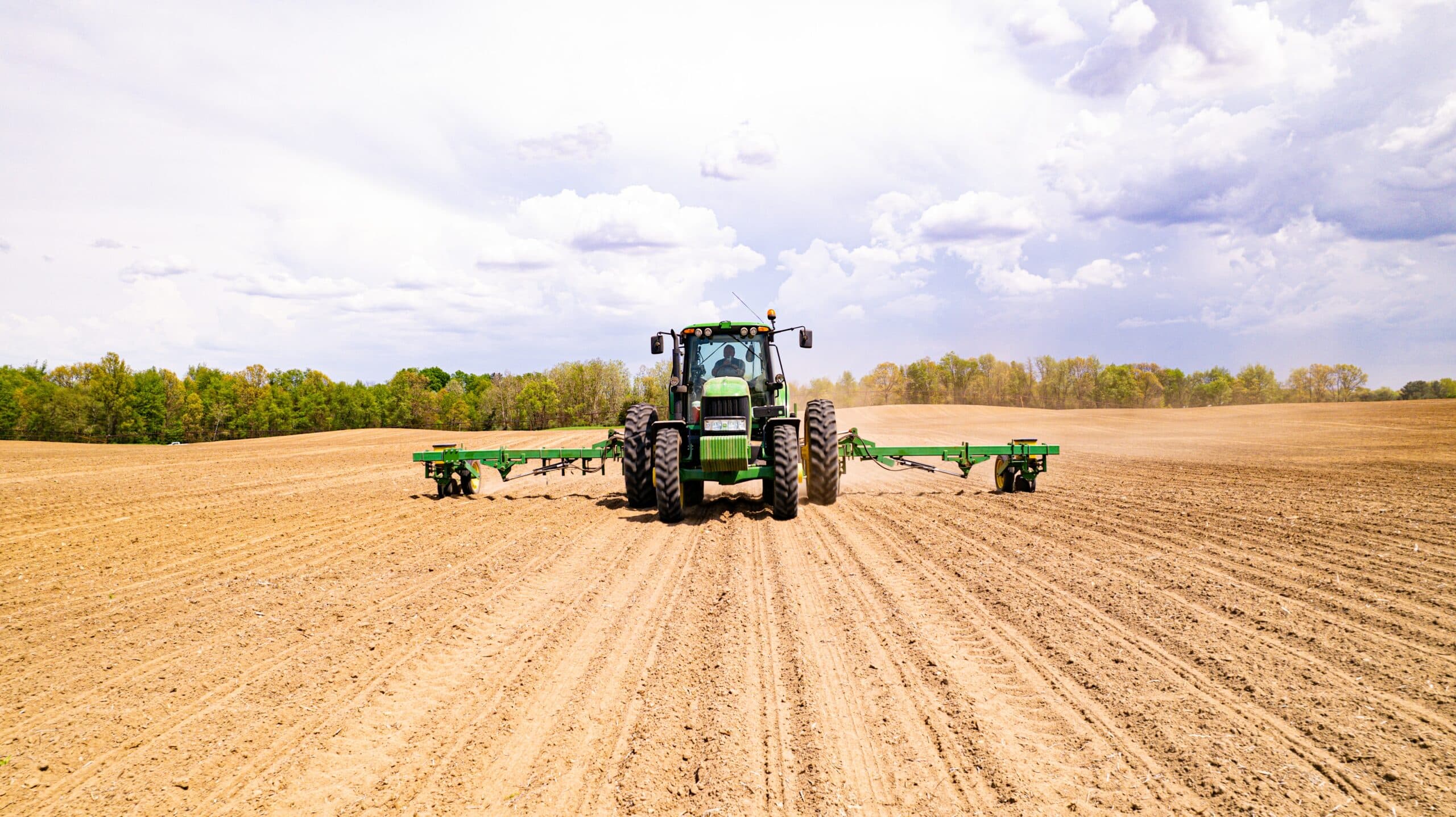Agricultural tractor operating in field, representing heavy duty tire service application