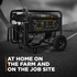 BE Power Equipment BE9000 portable generator being rolled on job site pavement