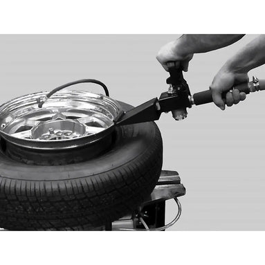 Technician using Coats ABS Auxiliary Bead Sealer on a tire mounted to a tire changer