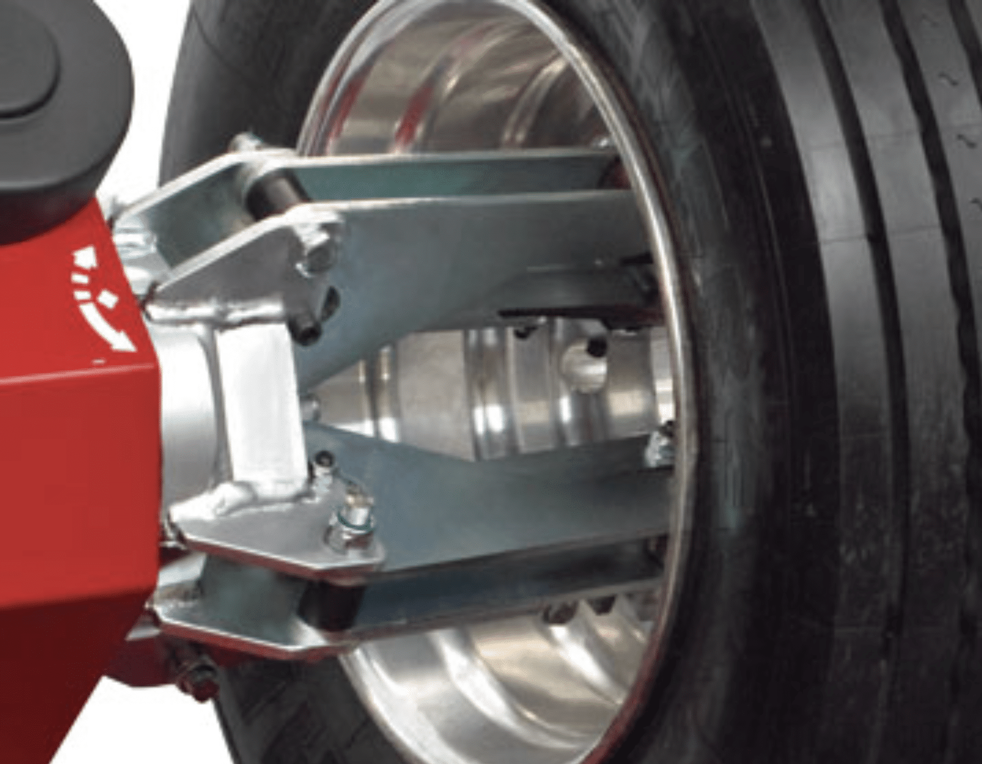 Coats CHD 6330 four-jaw chuck gripping a truck wheel rim close-up
